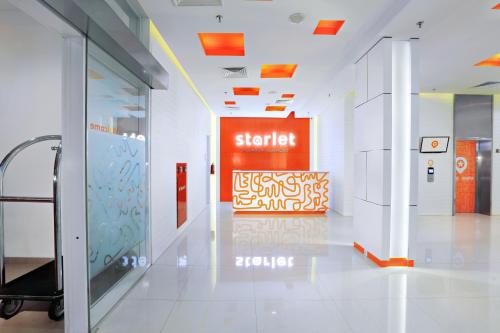 a hallway of an office with an orange sign on the wall at Starlet Hotel Jakarta Airport in Tangerang