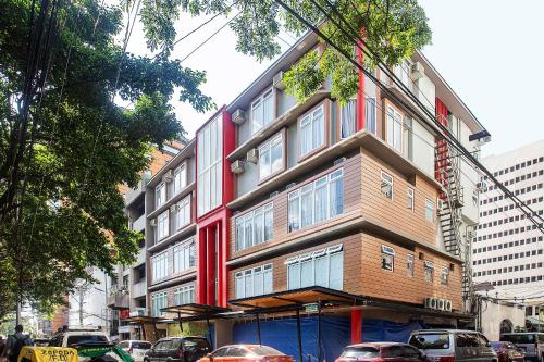 a building on a street with cars parked in front of it at Airo Hotel Manila in Manila