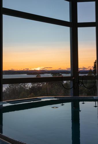 a view of the sunset from a swimming pool at Hotell Wilhelmina in Vilhelmina