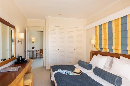 a hotel room with a bed with a hat on it at Anissa Beach Hotel in Hersonissos