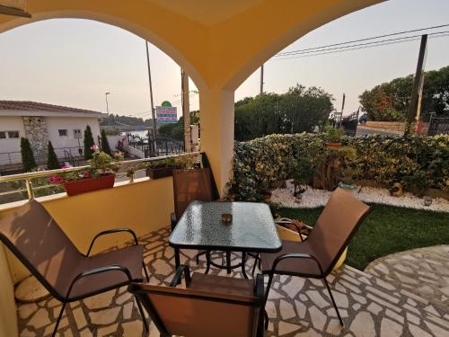 a patio with a table and chairs on a patio at Apartments Val Maslina in Utjeha