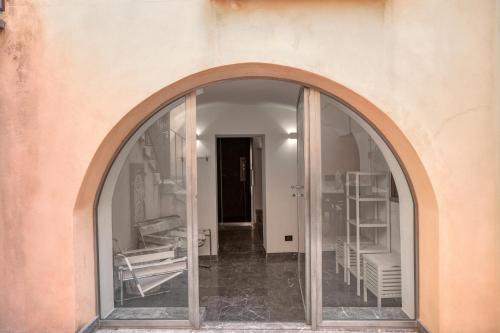 an archway in a building with a room with shelves at Villa Bordonaro - by Vacation Service in Cefalù