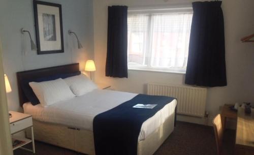 a hotel room with a bed and two lamps at The Old Dairy Liverpool in Liverpool