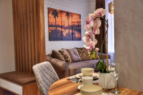 a living room with a couch and a table at Blaumana Residence Apartments in Rīga