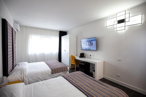 Säng eller sängar i ett rum på Hotel La Compagnia Del Viaggiatore