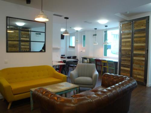 a living room filled with furniture and a tv at Agora Hostel in Estella