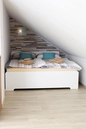 a bedroom with a bed with a wooden headboard at Apartmány v podhradí in Bečov nad Teplou