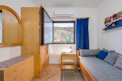 a small bedroom with a bed and a window at Jelena Sumartin in Sumartin