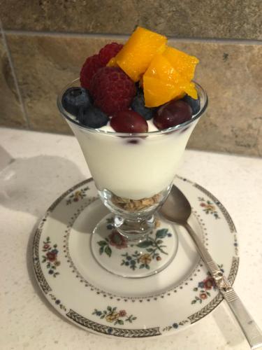 a bowl of fruit on a plate with a spoon at Jonan House in Deal