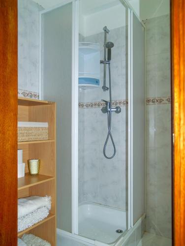 a shower with a glass door in a bathroom at Apartamento Sintra in Sintra