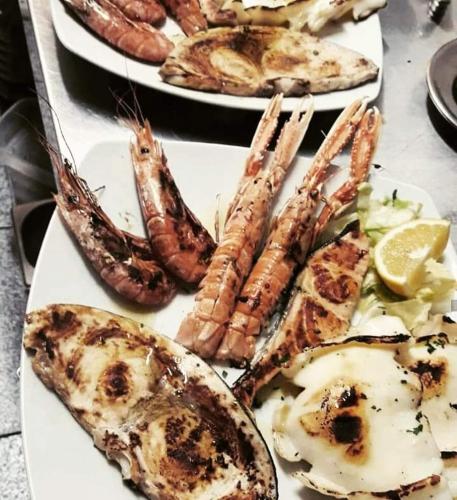 a plate of food with different types of seafood at Hotel Mariagrazia in Calopezzati