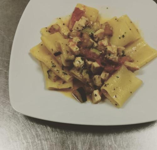 a white plate of food on a table at Hotel Mariagrazia in Calopezzati