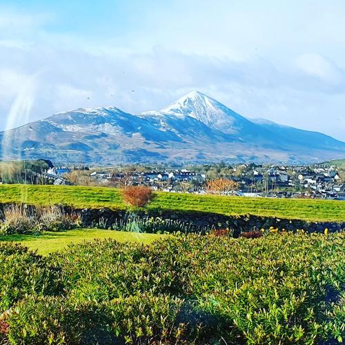 a mountain in the distance with a town in the foreground at Cong Getaway Lodge in Mayo