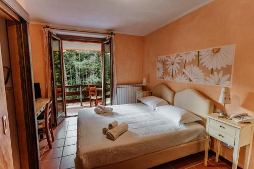 A bed or beds in a room at Vallicciola Nature Hotel