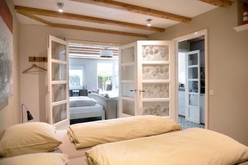 a room with two beds and a room with a bedroom at Family House Amsterdam in Amsterdam