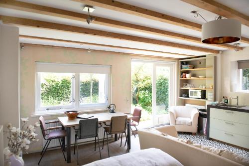 a kitchen and living room with a table and chairs at Family House Amsterdam in Amsterdam