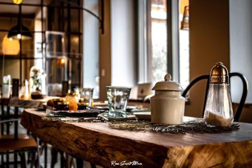 a wooden table with a tea kettle on top of it at Logis Hotel Nature Cathare in Léran