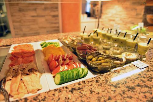 a buffet of different types of food on a counter at Lobinger Hotel Weisses Ross in Langenau