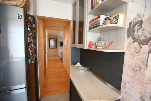 a kitchen with a stainless steel refrigerator and a hallway at Park View Apartment in Kaunas