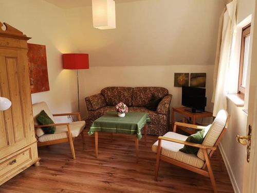 a living room with a couch and a table at Ferienwohnung Bachforelle in Neuenkirchen