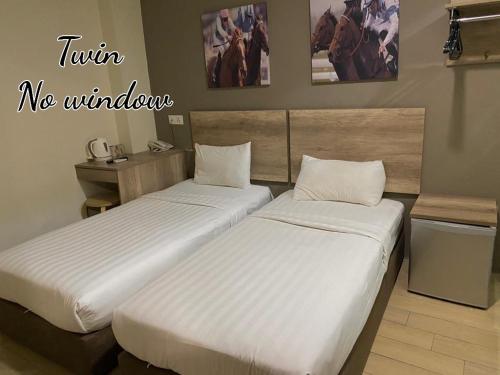 two beds in a hotel room with at SH Hotel Kota Damansara in Kota Damansara