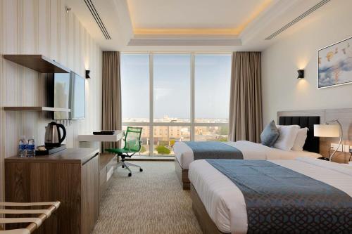 Postel nebo postele na pokoji v ubytování The Proud Hotel Al Khobar