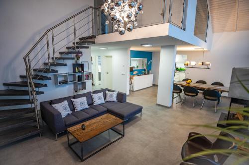 a living room with a couch and a staircase at Mein Beach House in Löbnitz