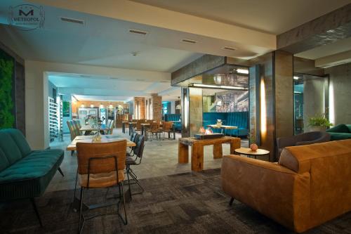 a lobby of a hotel with tables and chairs at Metropol in Śrem