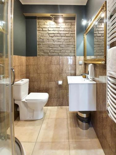 a bathroom with a toilet and a sink at Kamienica Morska Gdynia in Gdynia