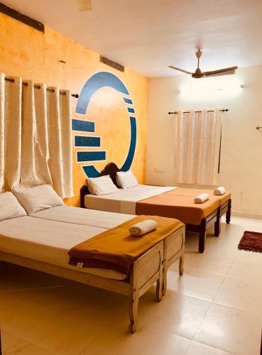 a room with two beds and a sign on the wall at Jungleview Home Stay in Idukki