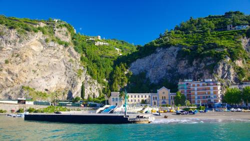 a body of water with a beach and a mountain at Sapore di Mare Holidays in Maiori