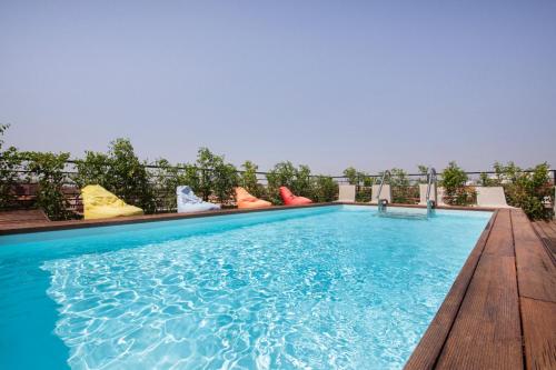 a swimming pool with a view of the ocean at Hôtel Ibn Batouta in Marrakesh