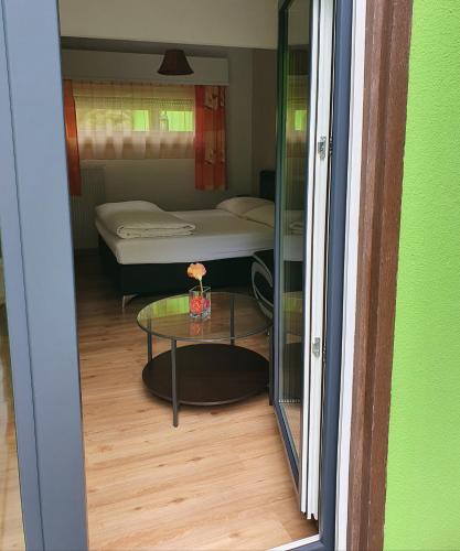 a view of a room with a table and a bed at Motel - Hôtel "Inter-Alp" à St-Maurice in Saint-Maurice