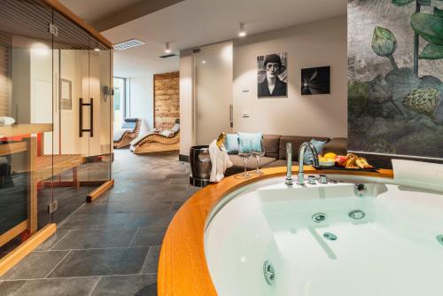 a large bathroom with a bath tub in a room at Suites Hotel Astor in Belluno