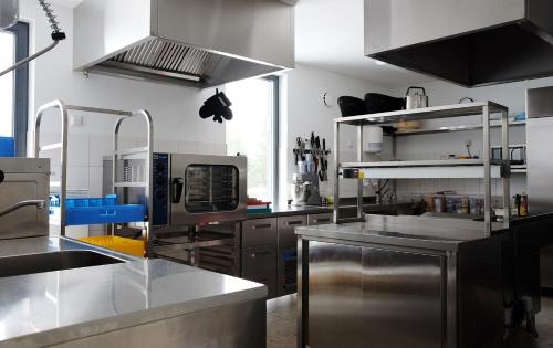 a large kitchen with stainless steel appliances in a kitchen at Kalaranna Holiday Home in Eisma