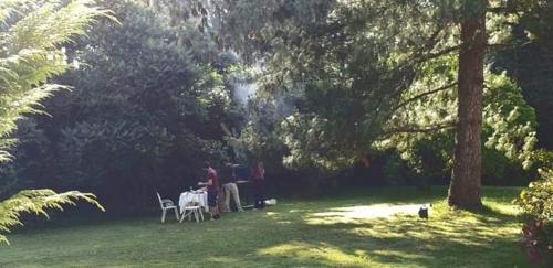 a group of people sitting at a table in a park at Crown Roads in Le Faouët