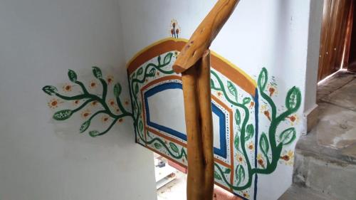 a wooden railing with a painting on a wall at Morada dos Elfos in Vale do Capao