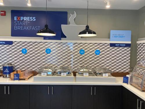 a store counter with blue and white tiled wall at Holiday Inn Express & Suites - Collingwood in Collingwood