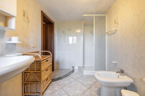 a bathroom with a sink and a toilet and a shower at Appartamento Chia C in Chia