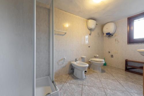 a bathroom with a toilet and a shower at Appartamento Chia C in Chia