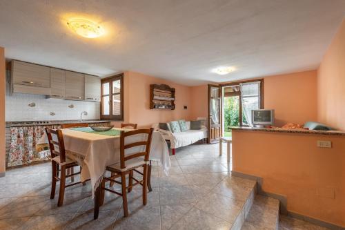 a kitchen and living room with a table and chairs at Appartamento Chia C in Chia