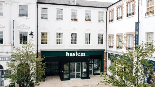 a white building with a green awning at Haslem Hotel in Lisburn