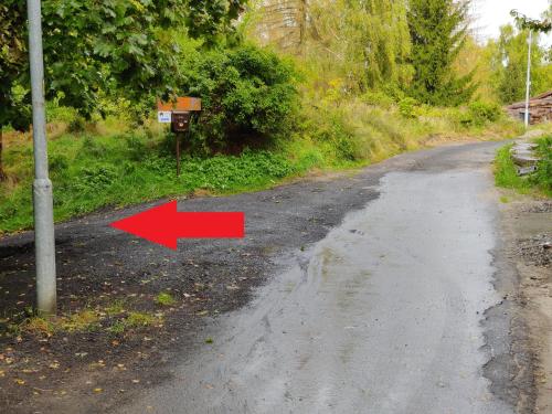an empty road with a red arrow on it at Mezná 85 in Hřensko