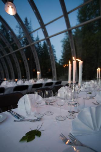a table with wine glasses and candles on it at Thon Hotel Oslo Airport in Gardermoen