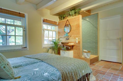 a bedroom with a bed and a shower and a sink at PYKES B&B in Goes