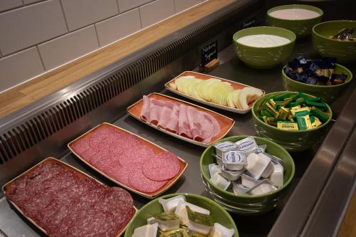 
a kitchen counter filled with lots of different types of food at Holiday Inn Preston, an IHG Hotel in Preston
