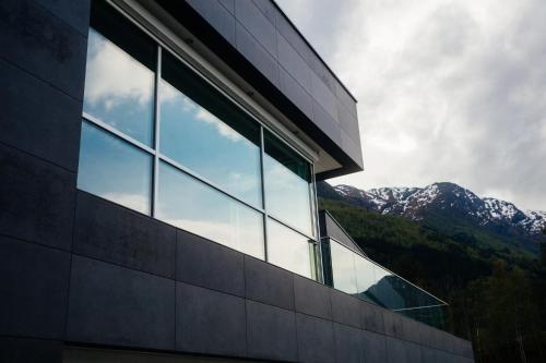 a window of a building with mountains in the background at Hardanger House in Jondal