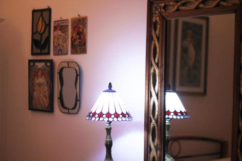 a mirror and a lamp in front of a mirror at Giljana ensuite rooms shared terrace & kitchen in St Julian's