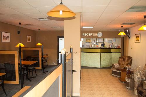 a lobby of a restaurant with a counter and chairs at PENSIUNEA MURY in Braşov