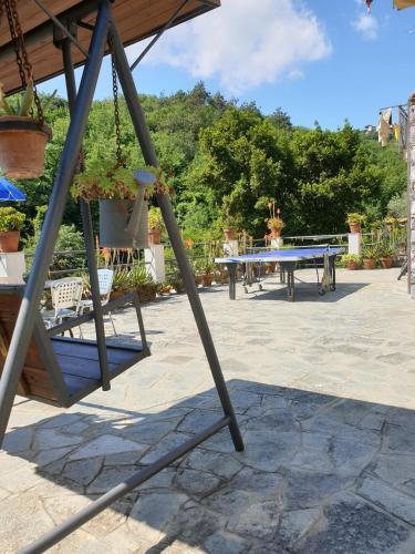 a patio with a ping pong table and a bench at B&B collina e mare in Camogli
